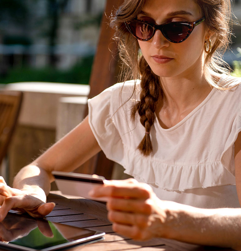 Young woman Paying online with credi card, Credit: StockRocket