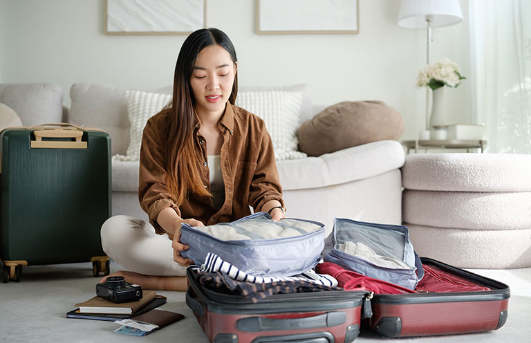 woman packing suitcase