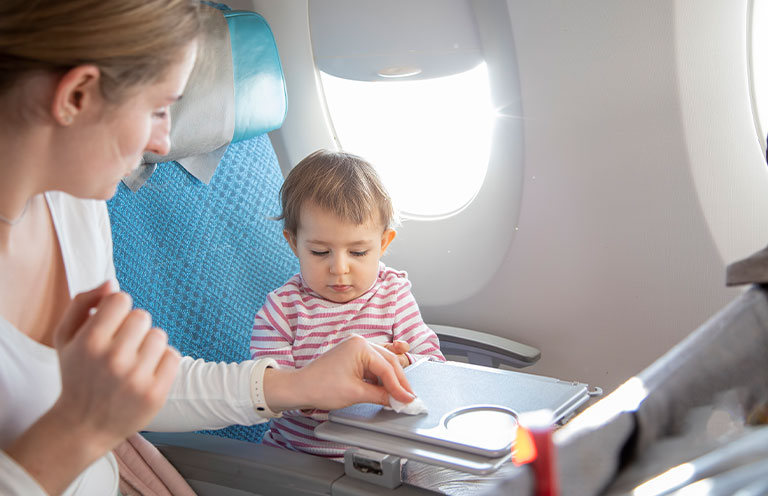 mom cleaning plane tray for child to eat