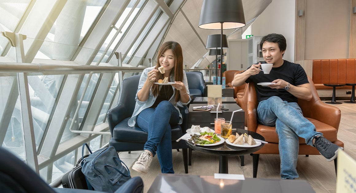 man and woman sitting in airport lounge