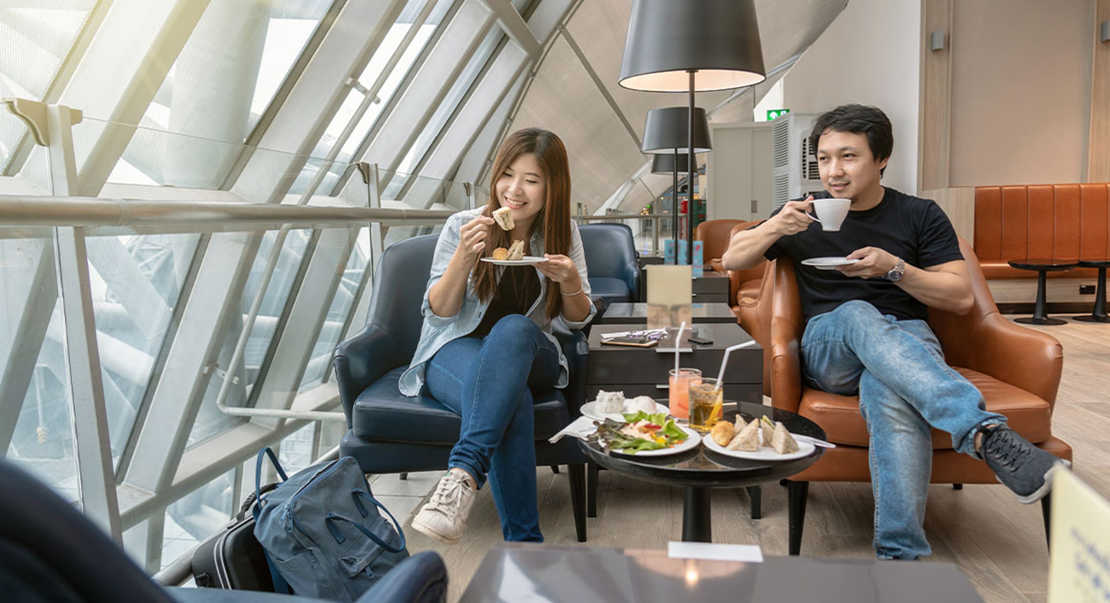 man and woman sitting in airport lounge