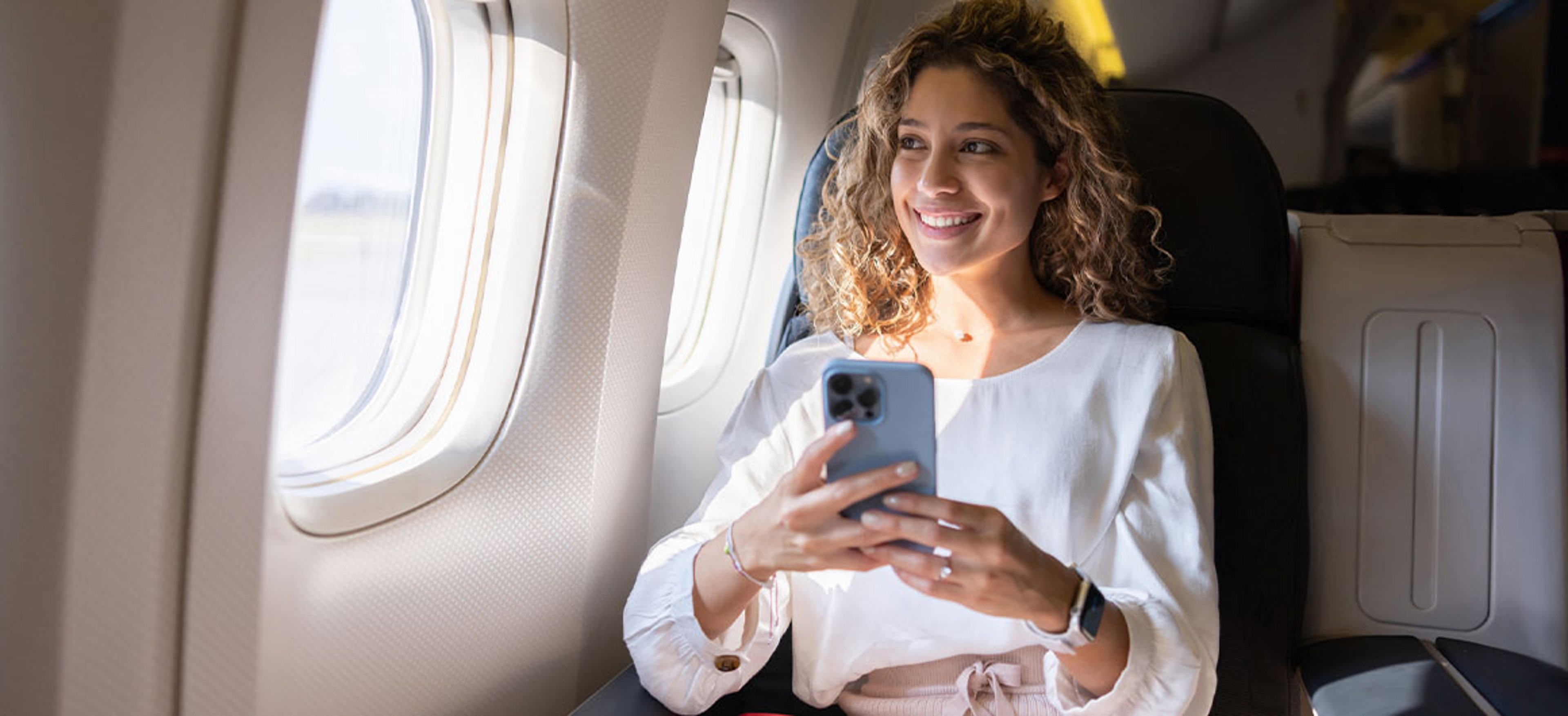 woman on plane using phone
