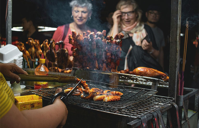 women looking at street food