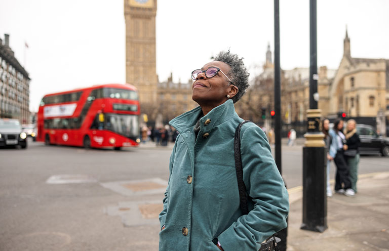woman looking up in at sky in downtown London