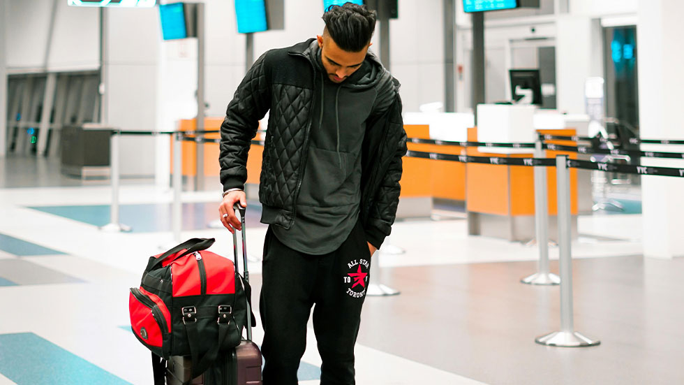 man in airport with luggage