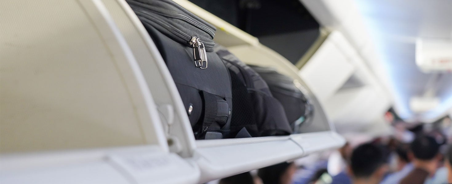 carryon luggage in overhead bin on plane