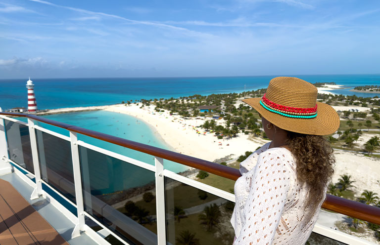 woman on cruise ship looking at lighthouse