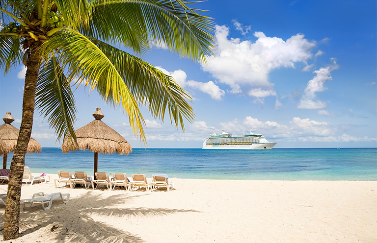View from tropical beach on cruise ship sailing from port