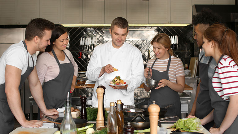 Chef and group of young people during cooking classes By Pixel-Shot