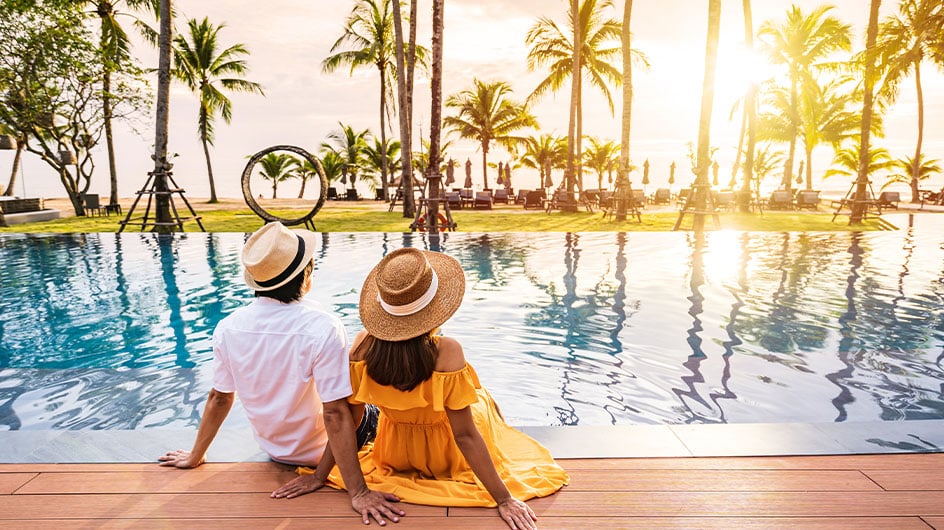 man and woman sitting by the pool
