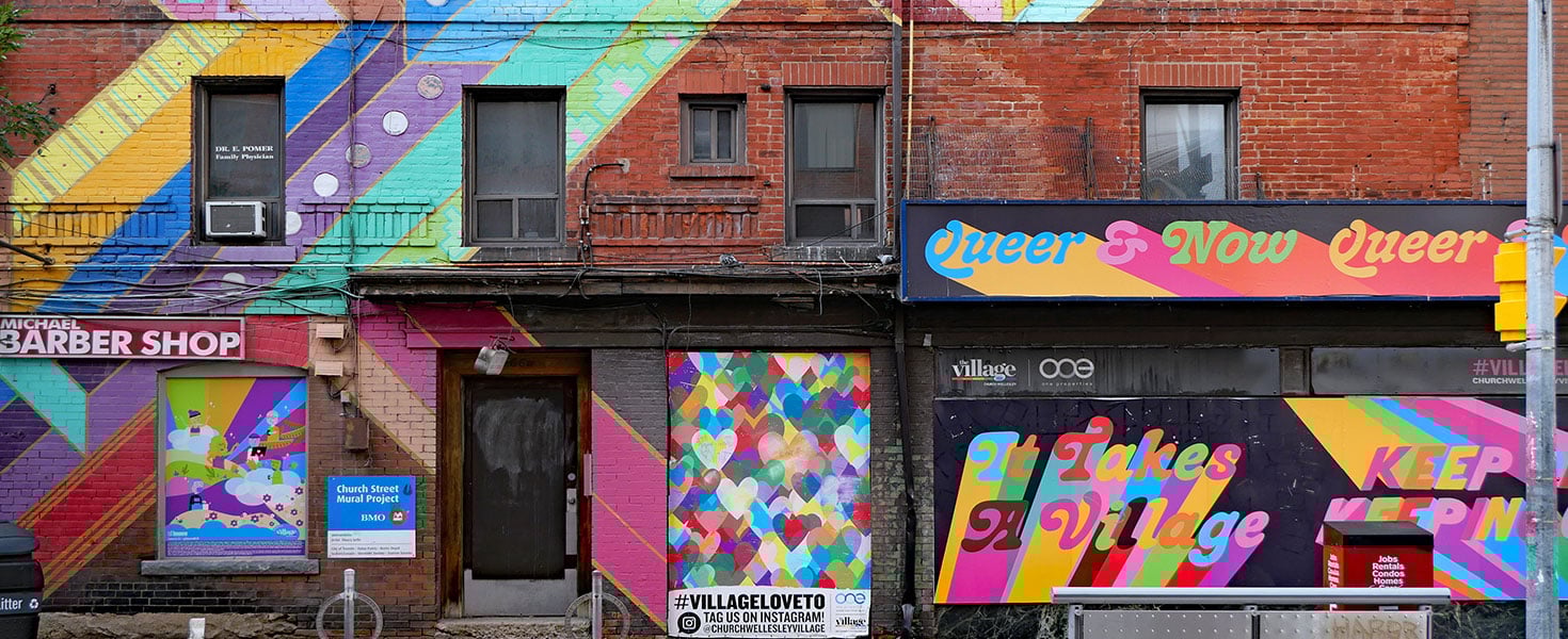 Colorful painted brick wall with rainbow colors in a gay village neighborhood. Photo by Spiroview Inc/adobe.stock.com