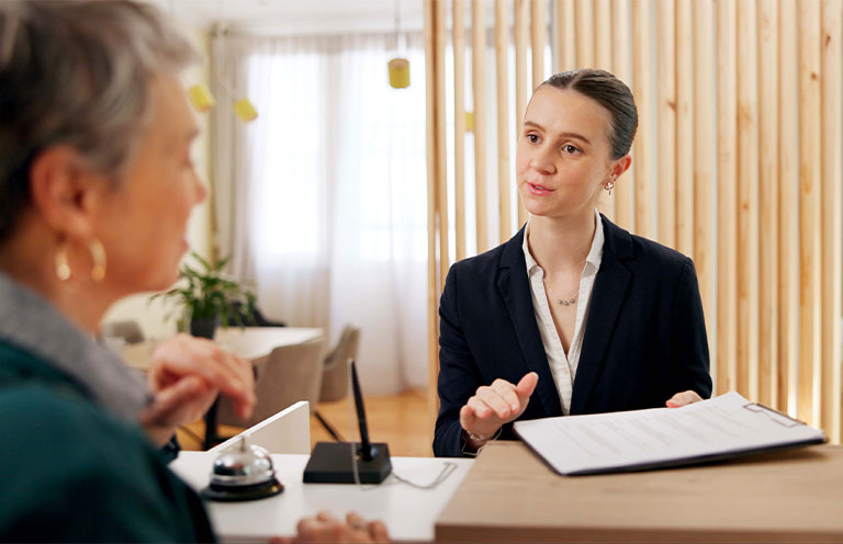 woman speaking to hotel manager