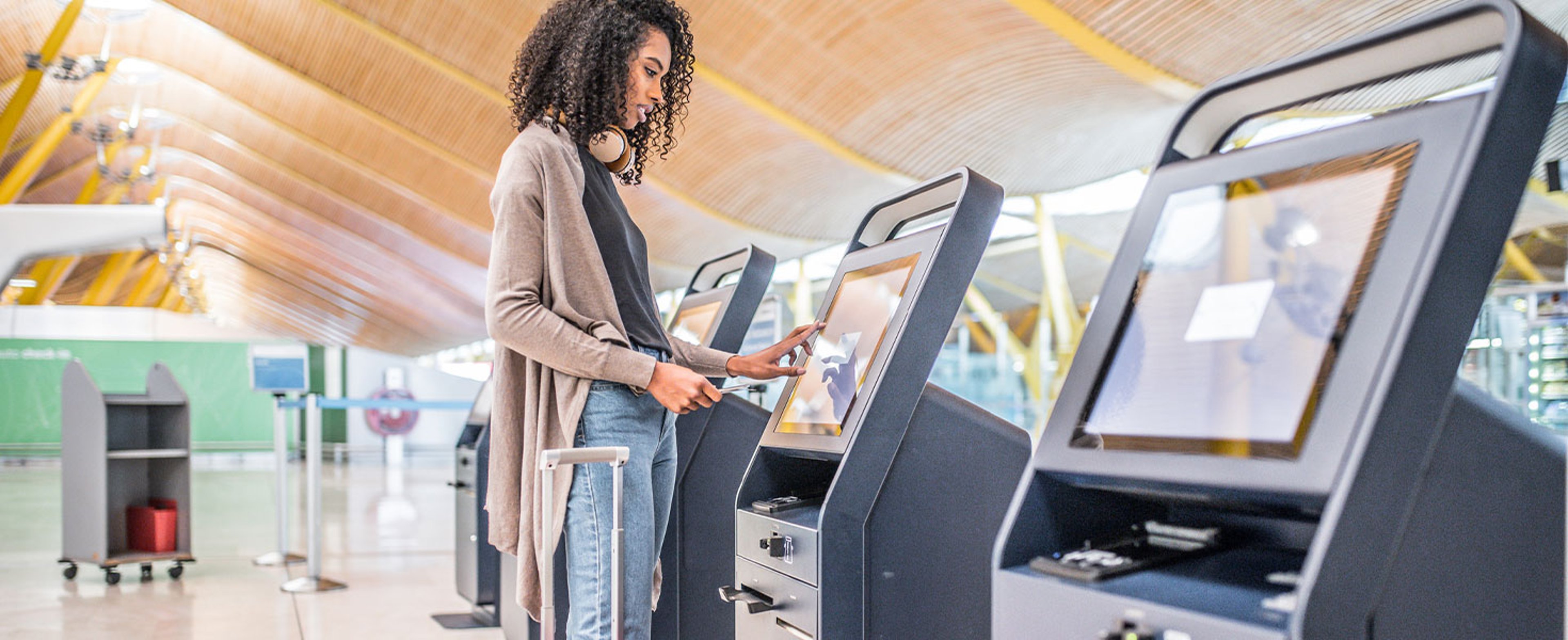 Woman standing at airport kiosk