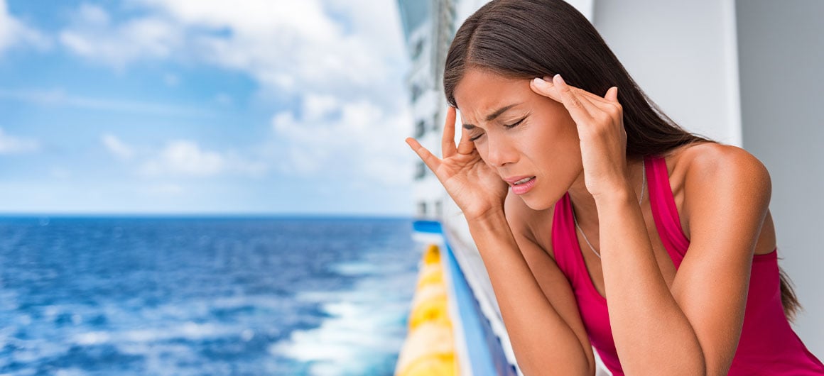woman rubbing her head on cruise ship