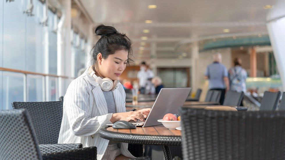 woman using laptop on cruise