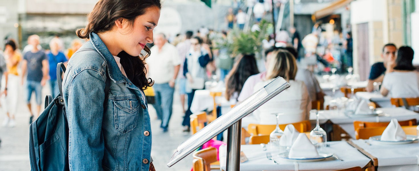 Young Tourist Woman Looking The Menu Of A Restaurant In The Seaport Of San Sebastian. Credit EyeEm Mobile GmbH