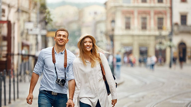 Travel. Tourist Couple Traveling, Walking On Street By puhhha