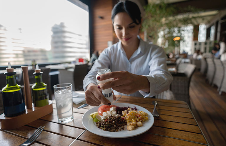 woman eating meal at hotel restaurant