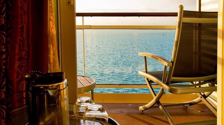 Empty Deck Chair on a Cruise Ship Balcony at Dusk. Credit: grandriver