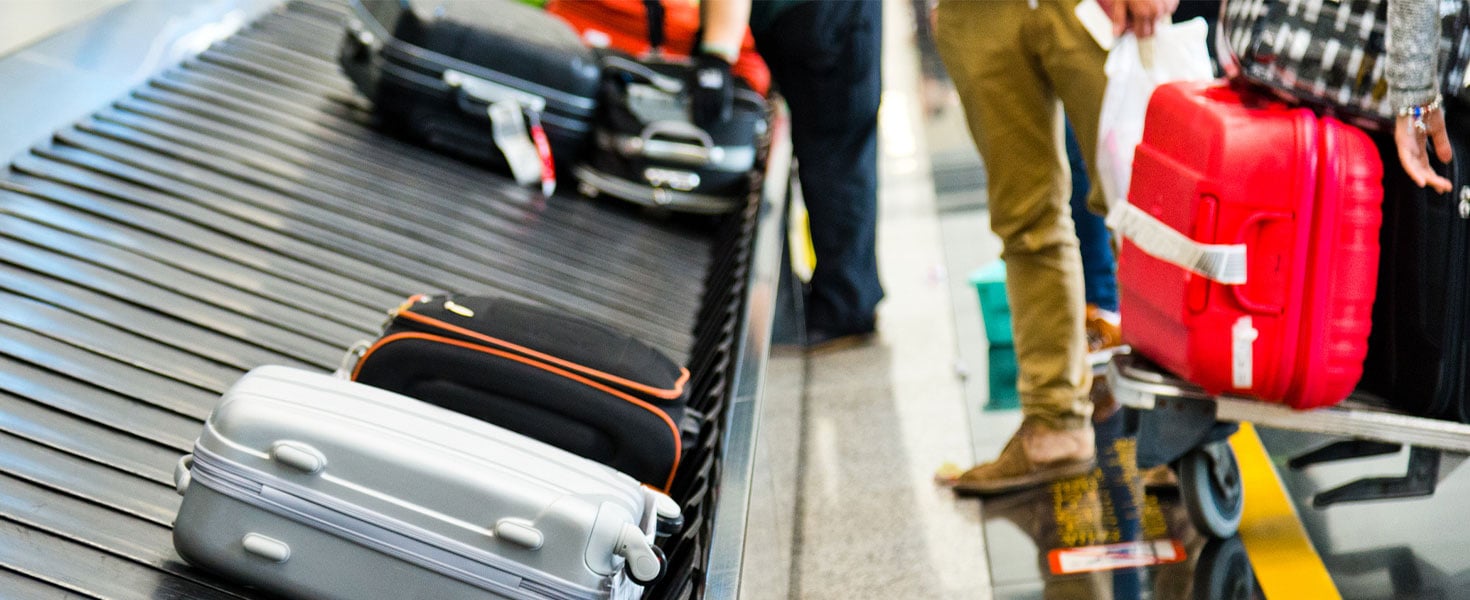 airport luggage carousel filled with suitcases