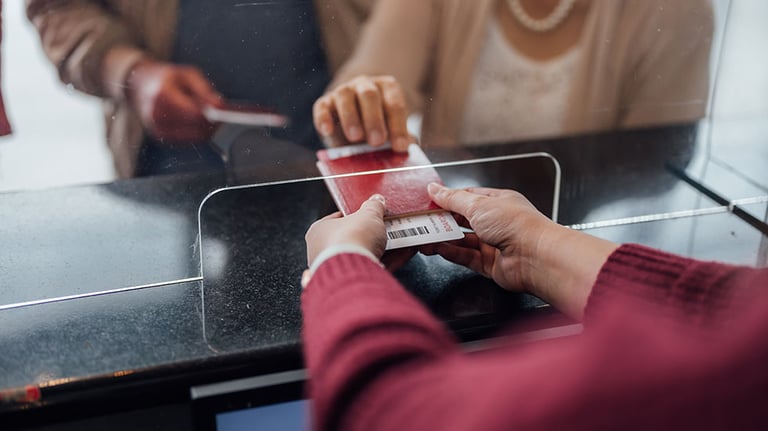 Young woman goes through self-check-in at the airport for her flight Credit: mihailomilovanovic