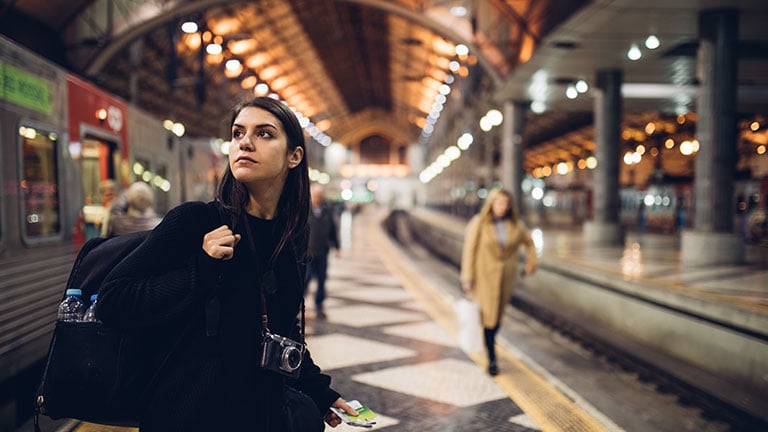 Female traveler searching for directions,waiting for the train/tram,using transportation in foreign country.Urban tourism.Low budget cheap ticket backpacking.Travel to the destination By eldarnurkovic