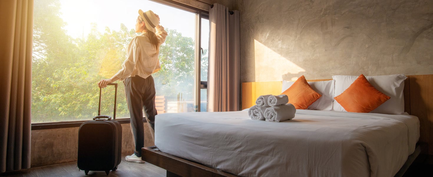 Woman looking out window in hotel