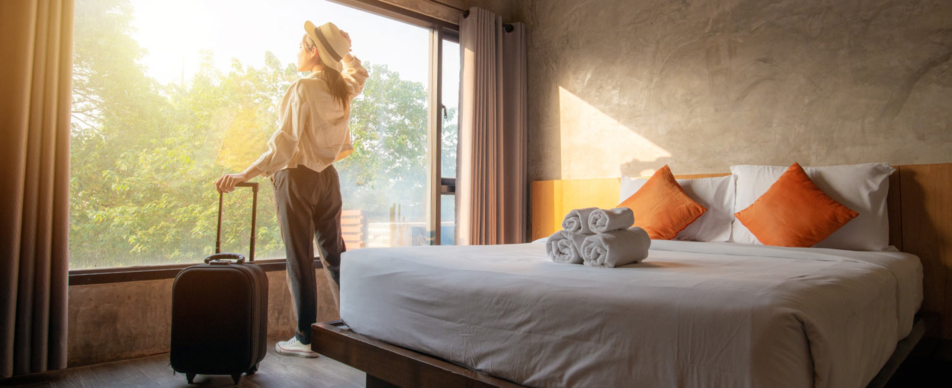 Woman looking out window in hotel