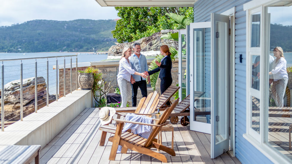 Couple on deck of house near water