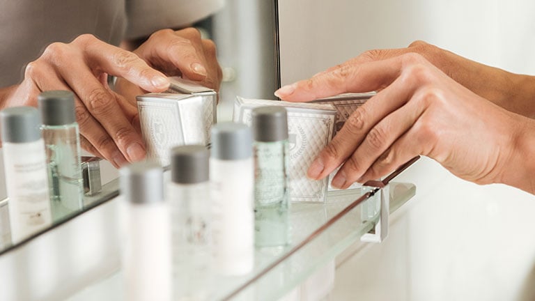 close up Square frame Tray with face towels hand soap and potted plant inside a clean bathroom