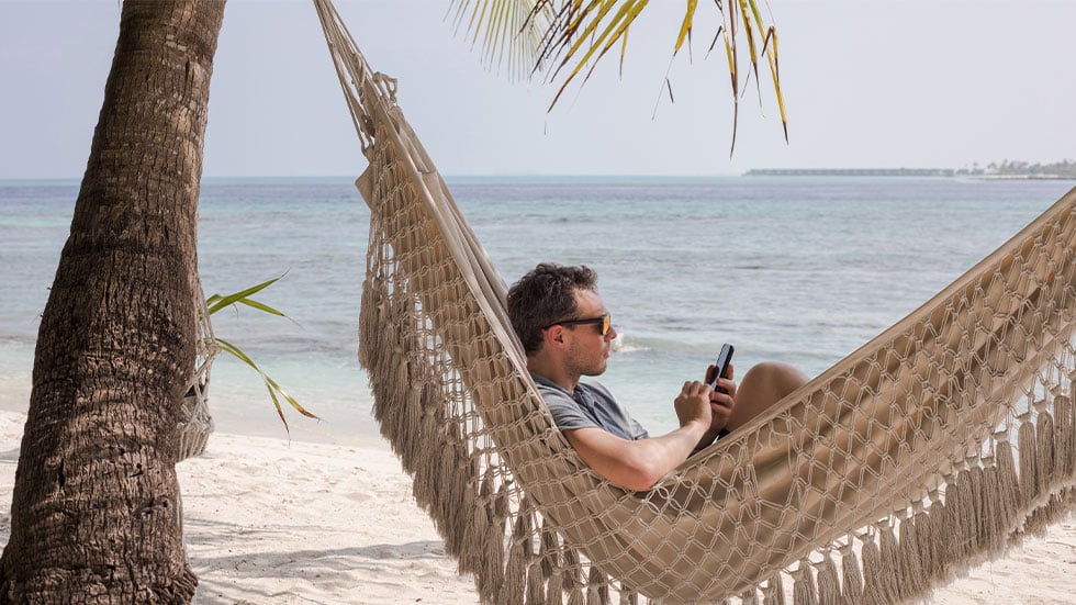 man on phone while in hammock
