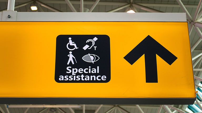 Signboard providing information for those in need of special assistance at the airport. By Hernan Schmidt