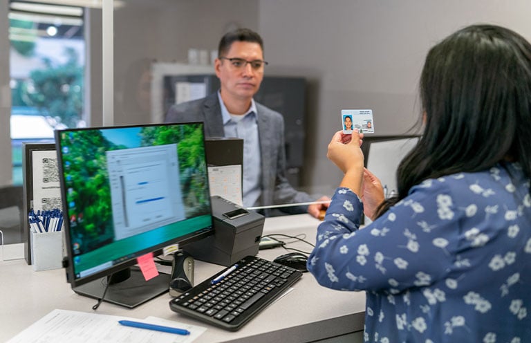 woman looking at id to identify man