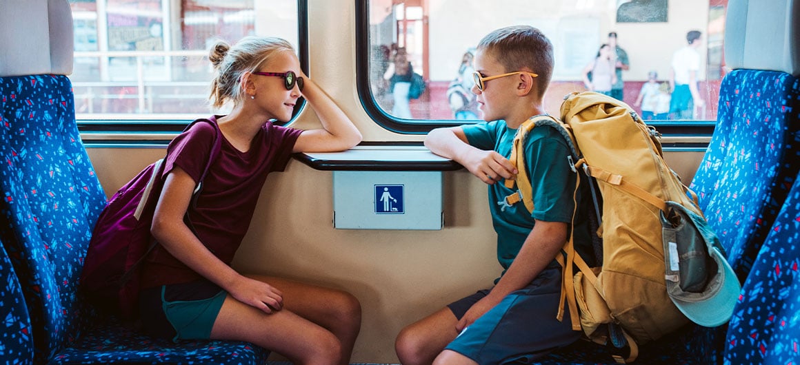two kids sitting on train
