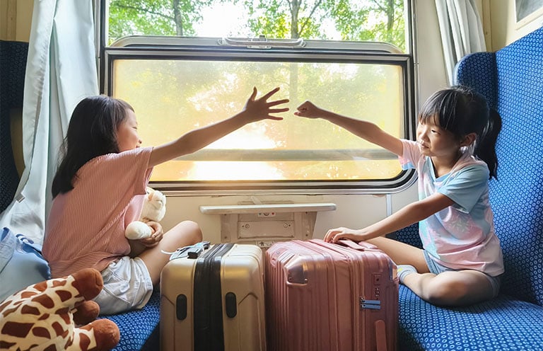 two kids playing on train