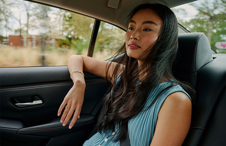 woman sitting in back seat of lyft ride