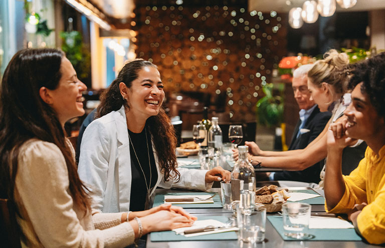 man and woman sharing pineapple smoothie with child