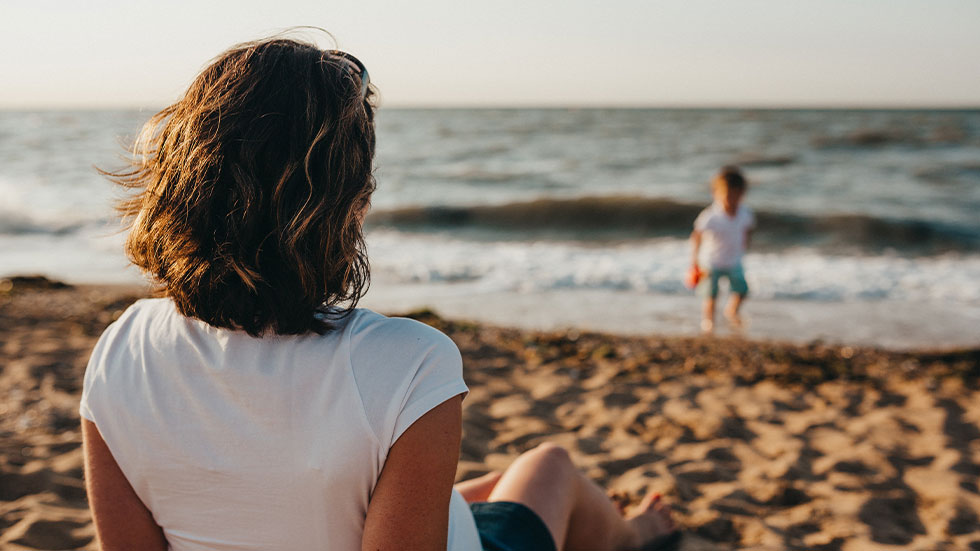 woman on beach with kid