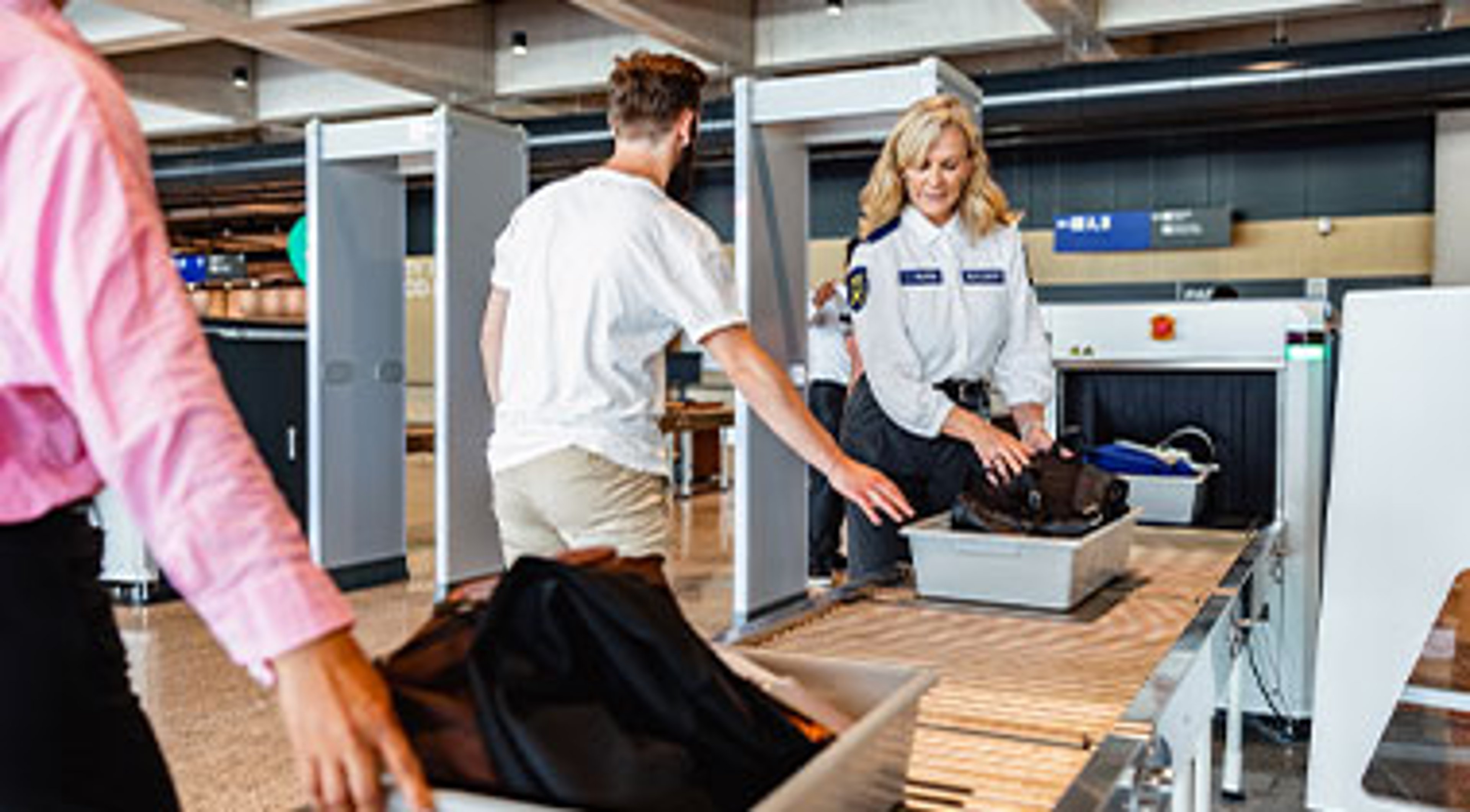 men going through airport security, tsa