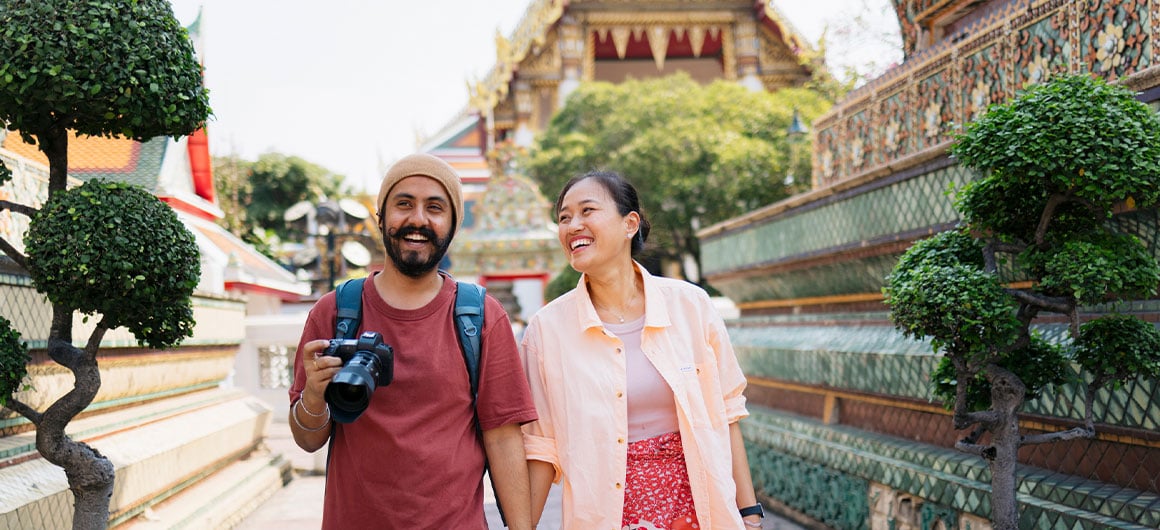 man and woman walking by tourist site