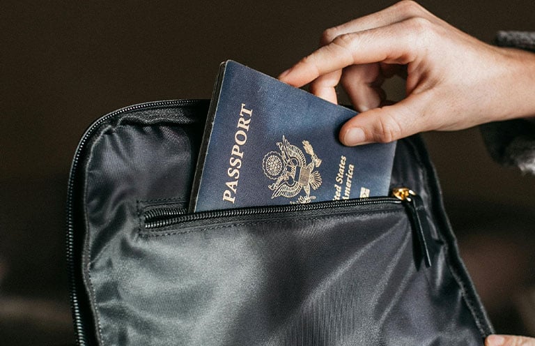 man putting passport in pouch