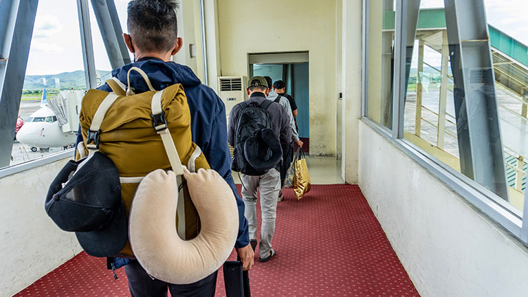 Passengers Waiting in Line for Their Flight by ArikEkaSatya