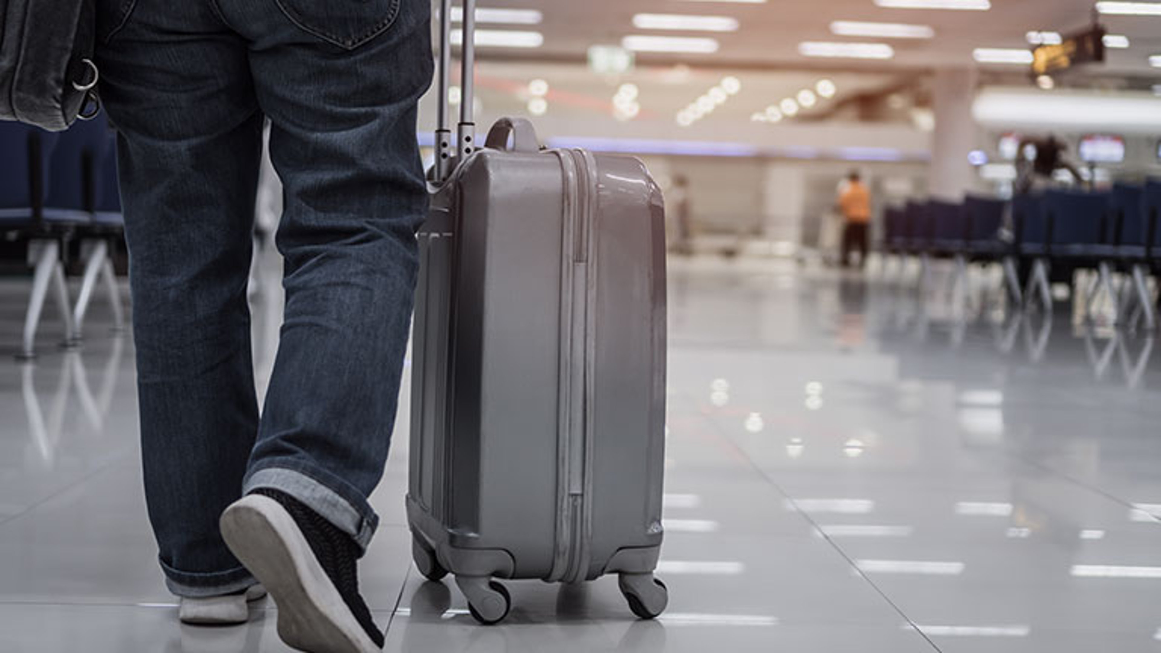 Traveler passenger hold luggage at terminal airport or transit flight with suitcase in journey vacation holiday at arrival international, No people in transportation during covid19 virus pandemic More by smolaw11