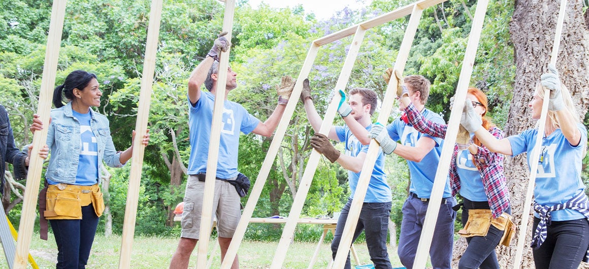 people putting together frame to build a structure 