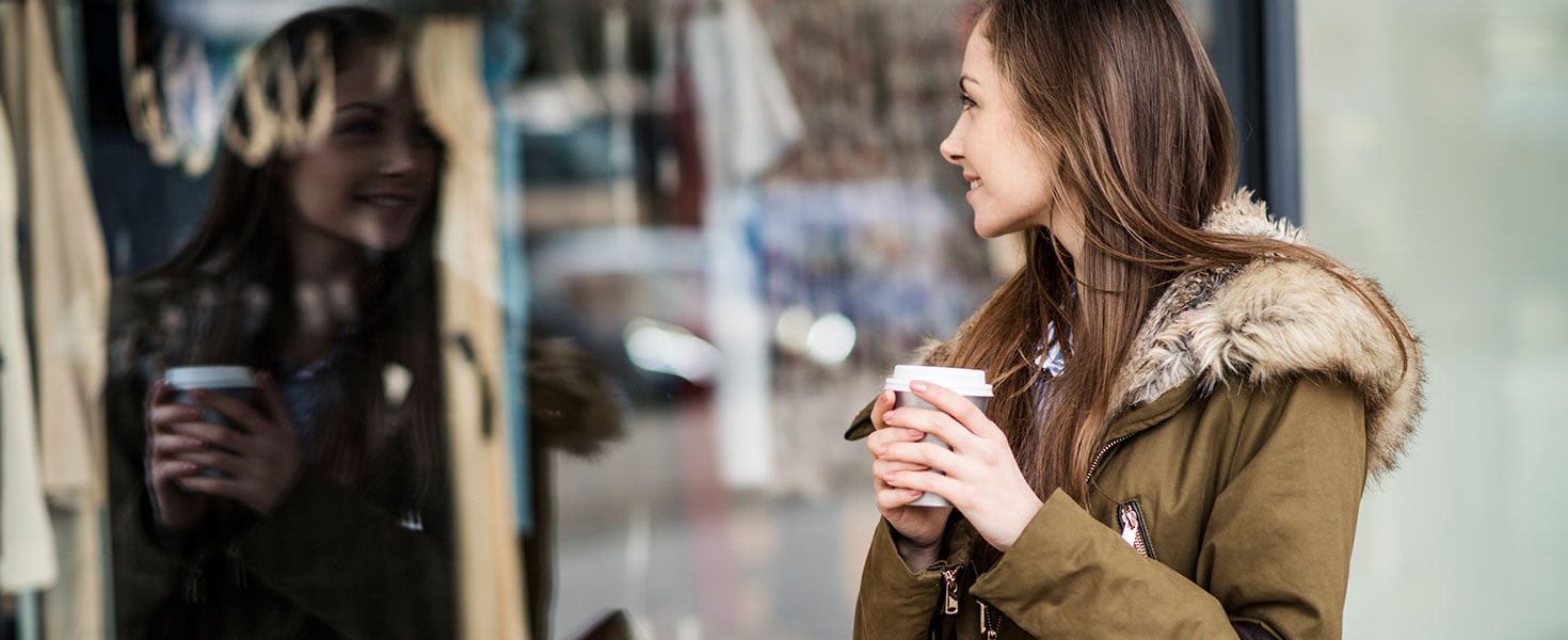 Woman window shopping on a cold day
