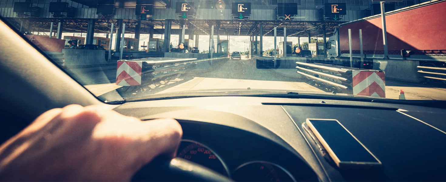 View of toll booths from inside of car