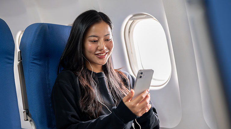 Woman in Denim Jacket Sitting inside the Plane; Credit: Alex P with Pexels