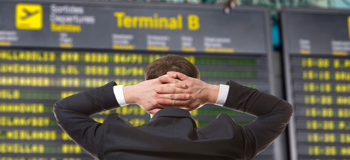 man looking at terminal flights, frustrated