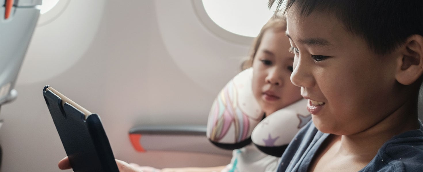 kids using tablet on plane