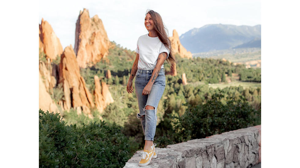 Woman walking on stone ledge